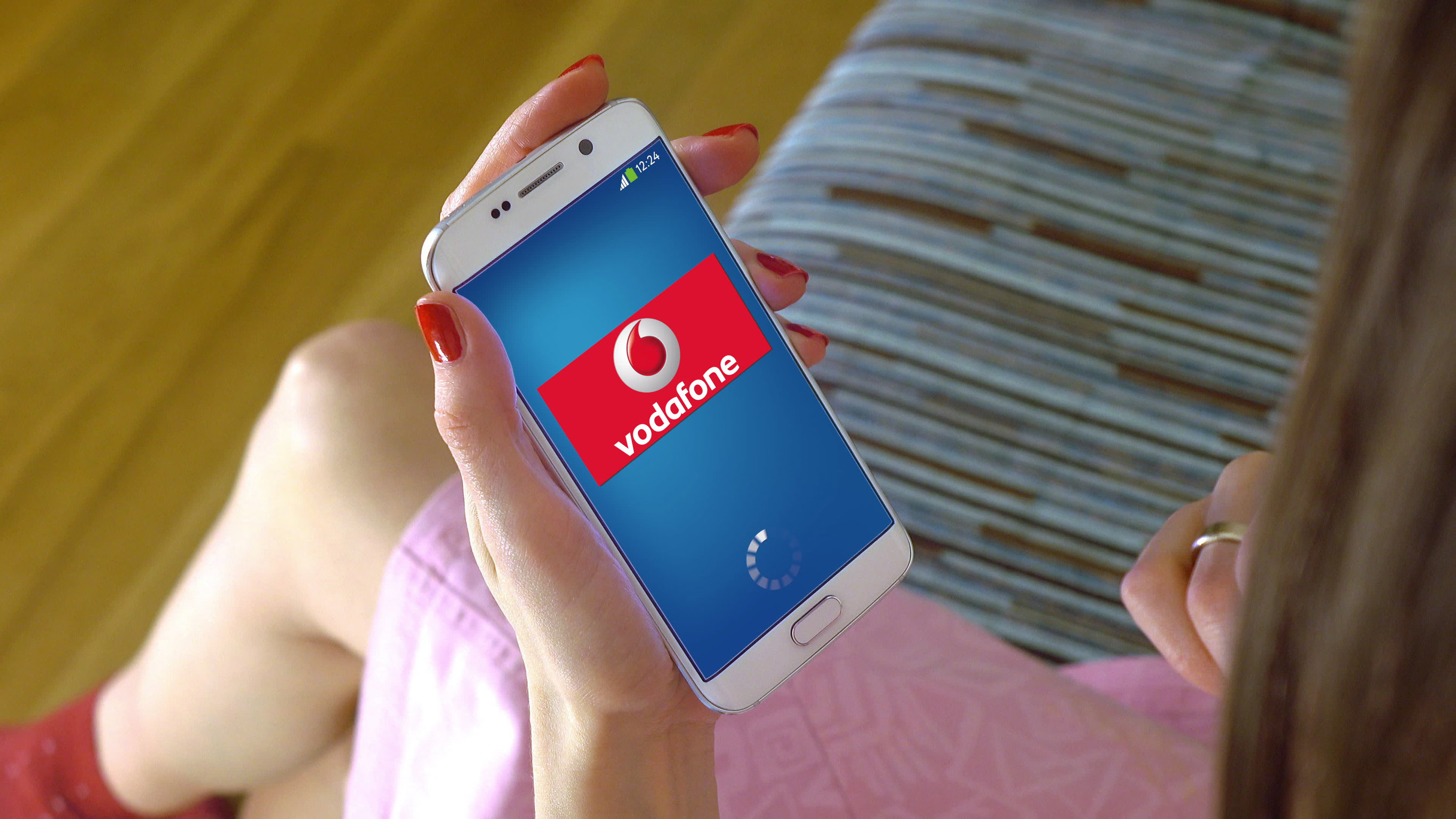 Smartphone in mano con logo Vodafone 